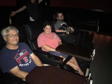 birthday with SMA | SMA News Today | Kevin and his parents sit in reclining chairs to watch a movie.