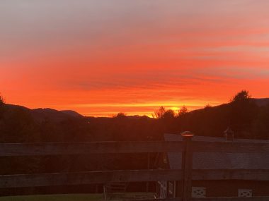 signs | SMA News Today | A stunning fiery red sky emerges from behind a mountain range as the sun sets in North Carolina