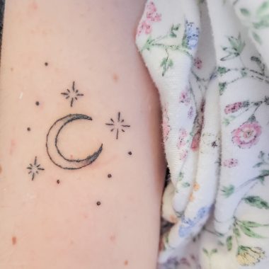 tattoo | SMA News Today | A crescent moon tattoo surrounded by three stars.