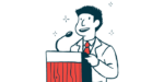 A speaker uses a microphone while standing at a podium.