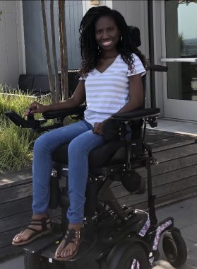 surviving law school | SMA News Today | 31 Days of SMA | photo of Shaniqua outside a home, in her wheelchair