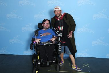 living with SMA | SMA News Today | Kevin Schaefer poses for a photo with Kevin Smith at a recent pop culture convention.
