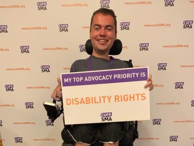 ASUCD | SMA News Today | Ryan Manriquez holds a sign that reads "My top advocacy priority is disability rights."