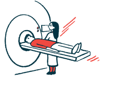 A technician stands in front of an MRI machine as a patient lying down prepares to be scanned.