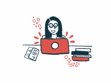 A woman works at a laptop computer.