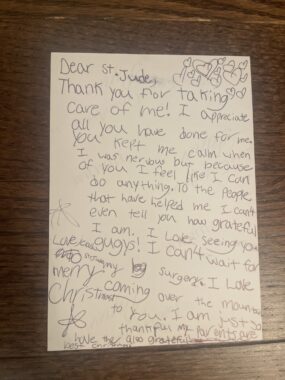 A handwritten note from a young girl is addressed to St. Jude and thanks the staff for taking care of her. 