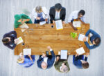 Overhead view of a team of healthcare providers sitting around a table