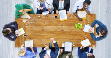 Overhead view of a team of healthcare providers sitting around a table