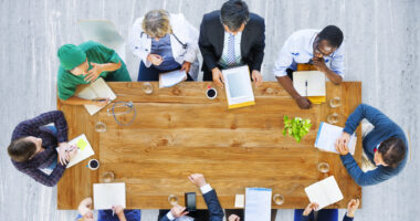 Overhead view of a team of healthcare providers sitting around a table