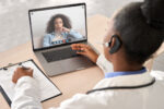 A female doctor talking to a female patient on a laptop in a telehealth visit