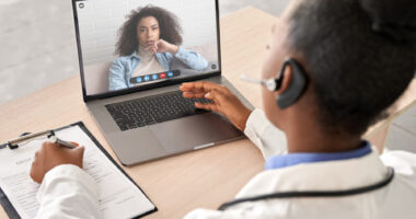 A female doctor talking to a female patient on a laptop in a telehealth visit