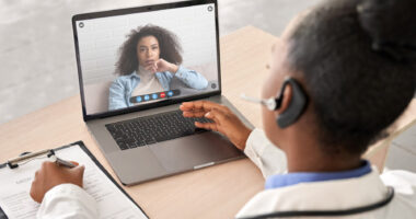 A female doctor talking to a female patient on a laptop in a telehealth visit