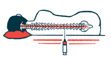 A large syringe with a needle is being used to deliver an injection directly into the spine of a patient lying down, who's seen from the back.