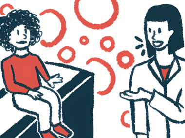 A therapist talks with a child seated on a bench.