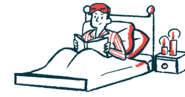 A person sits in bed reading a book.