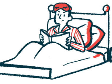 A person sits in bed reading a book.
